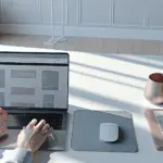 A modern workspace with a sleek laptop showing a wireframe homepage, highlighting WordPress web design trends for 2025.